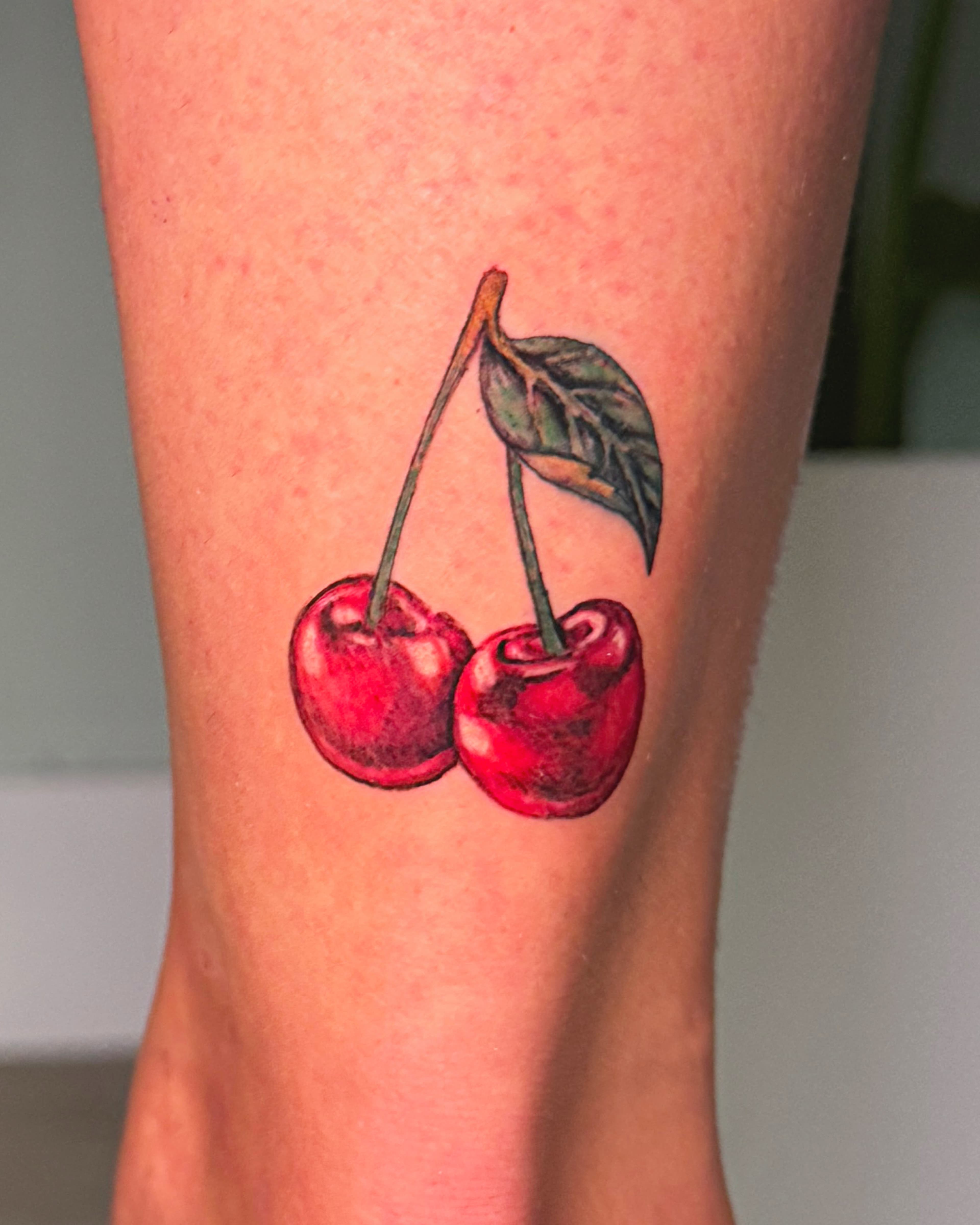 Cherry colour realism tattoo by Lydia Szubert